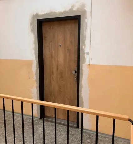 Bezpečnostní dveře SECUM po montáži, dřevodekor, pohled z chodby u schodiště